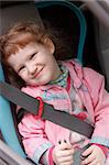 Cute little girl in a baby car seat