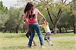 Back shot of a family  playingin the park,outdoor