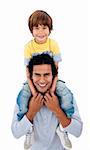 Happy father giving his son piggyback ride against a white background