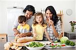 Jolly family preparing lunch together in the kitchen