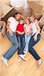 Smiling family lying on the floor while moving house