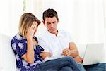 Distressed couple at home angry with so many bills to pay