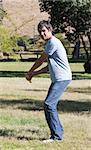 Handsome man playing baseball in the park