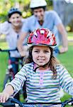 Cute little girl riding a bike in a park