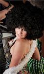 Pretty girl with afro wig and boa at a 1970s Disco Music Party