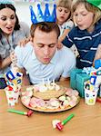 Joyful family celebrating father's birthday in the kitchen