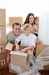 Happy family packing boxes while moving house