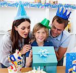 Loving parents celebrating their son's birthday in the kitchen