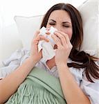 Young sick woman lying on the sofa at home