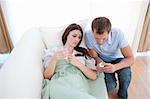 Man giving pills to his sick wife lying on the sofa