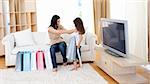 Mother and her daughter having fun at home after shopping