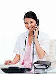 Asian doctor talking on phone against a white background