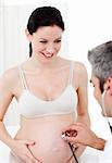 Pregnant woman and her gynecologist in his surgery