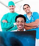 Smiling male doctors looking at X-Ray in hospital