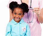 Adorable little girl attending medical check-up isolated on a white background