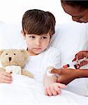 Sick little boy receiving an injection in a hospital