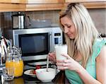 Charming woman having an healthy breakfast in a kitchen at home