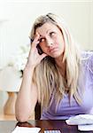 Frustrated woman having financial problems in a living-room