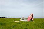 Young woman relaxing on a beautiful green meadow