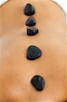 Lucky woman getting spa treatment with stones