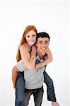 Teen giving his friend piggyback ride against white background