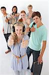 Happy teenagers smiling at the camera agaisnt white background