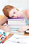 Tired teeenager sleeping on books after studying long time