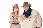 Couple in western wear pointing pistols with serious faces