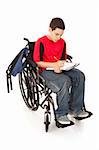 Disabled teenage boy doing homework in his wheelchair.  Full body isolated.