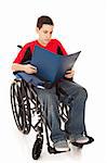 Disabled teen school boy reading in his wheelchair.  Full body isolated.