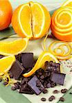 Decoratively prepared navel oranges with blocks and shards of dark chocolate.