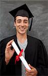 Smiling teen Guy Celebrating Graduation in the class