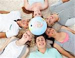 Teenagers on the floor with a terrestrial globe in the center of their heads