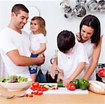 Young family cooking together in the kitchen at home