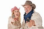 Couple in western wear pointing pistols and laughing