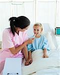 Young nurse attending a child patient in a hospital