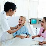 Smiling doctor attending a young patient in a hospital