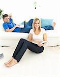 United couple reading book in the living-room at home