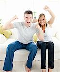 Charming couple having free time together in the living-room