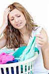 Disapointed woman doing laundry against a white background