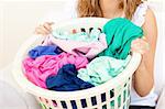 Close-up of a caucasian woman doing laundry against a white background