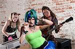 Young all girl punk rock band performs in front of brick wall