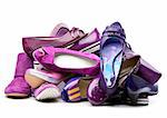 Pile of female violet shoes isolated on white background