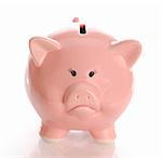 sad or frowning piggy bank money box with reflection on white background