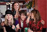 Charismatic young hipster with three female friends at a cafe