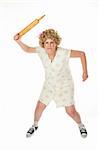 Angry housewife with rolling pin on white background
