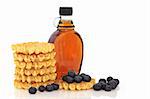 Blueberry fruit with waffles and maple syrup, isolated over white background.