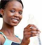 Woman drinking water against white background