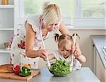 Blond mother and child cooking in kitchen