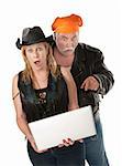 Biker couple surprised about something on a laptop